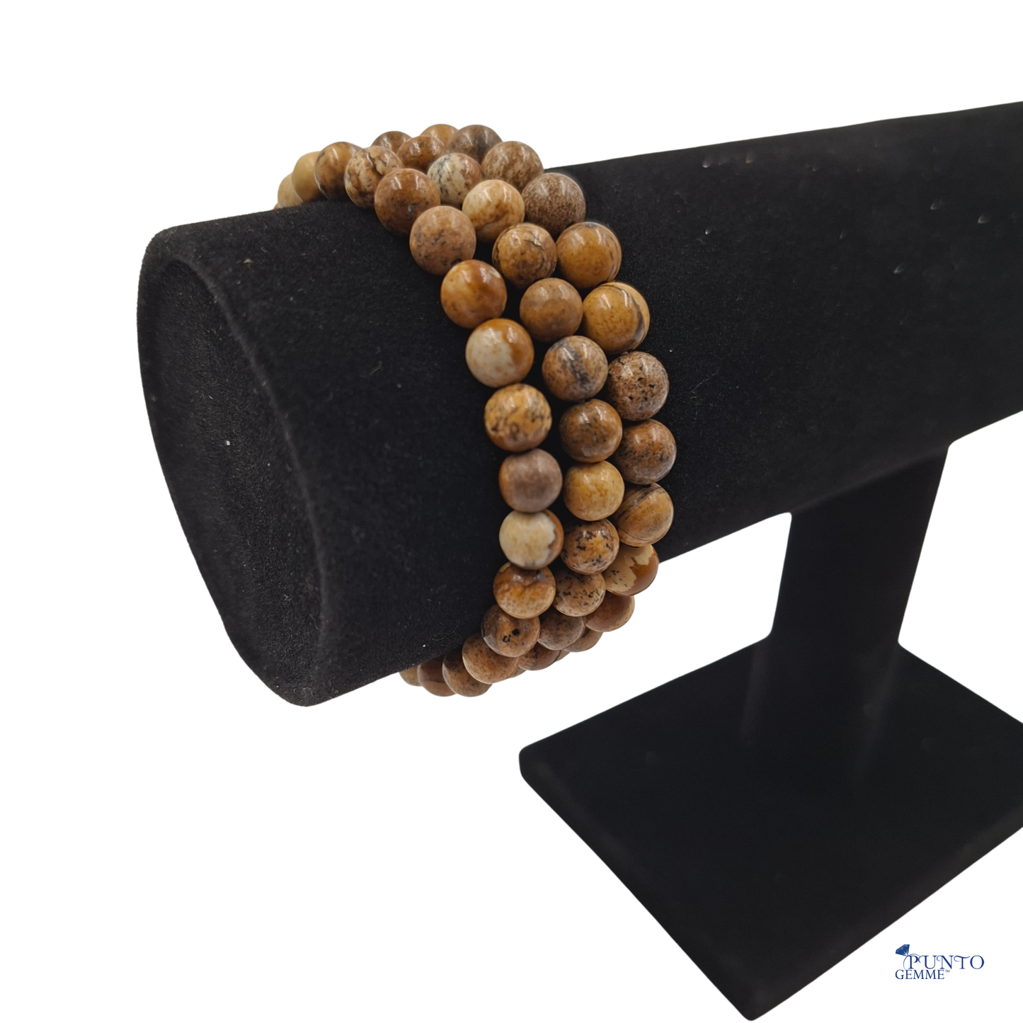 Dettaglio ravvicinato delle perle di Pietra Paesina , che mostrano le variazioni naturali e le venature marroni/beige.