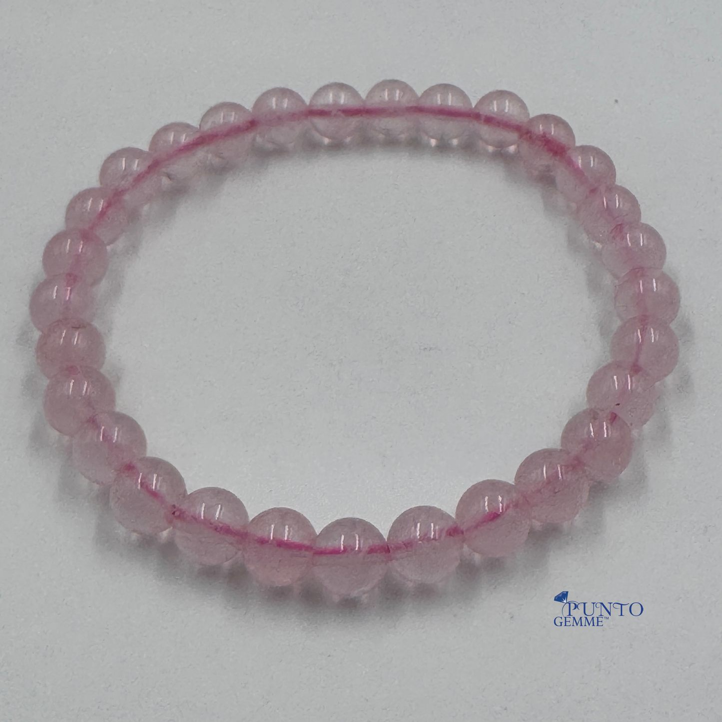 Foto completa del bracciale Quarzo Rosa 6mm tondo liscio (Taglia M), colore rosa pallido.