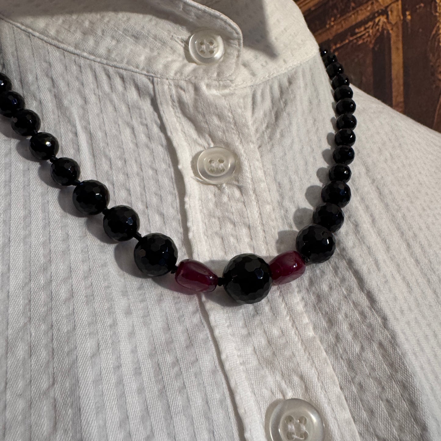 Dettaglio ravvicinato della sinergia tra Agata Nera e Rubini (A0009), la combinazione di terra e fuoco regale.