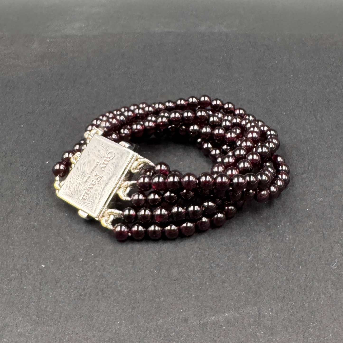 Guy Favia three-strand bracelet in red garnet and astrophillite with 925 silver clasp