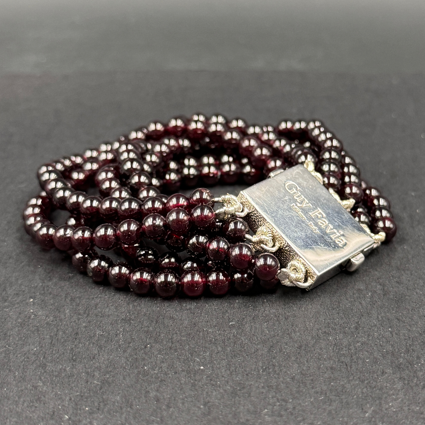 Guy Favia three-strand bracelet in red garnet and astrophillite with 925 silver clasp
