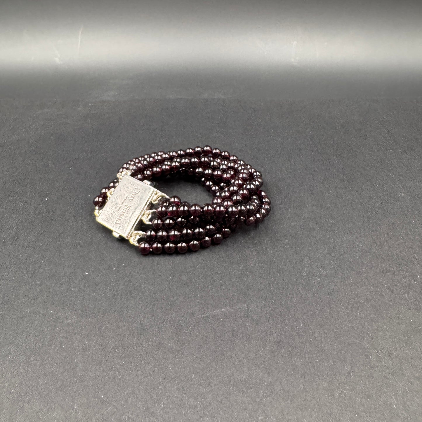 Guy Favia three-strand bracelet in red garnet and astrophillite with 925 silver clasp