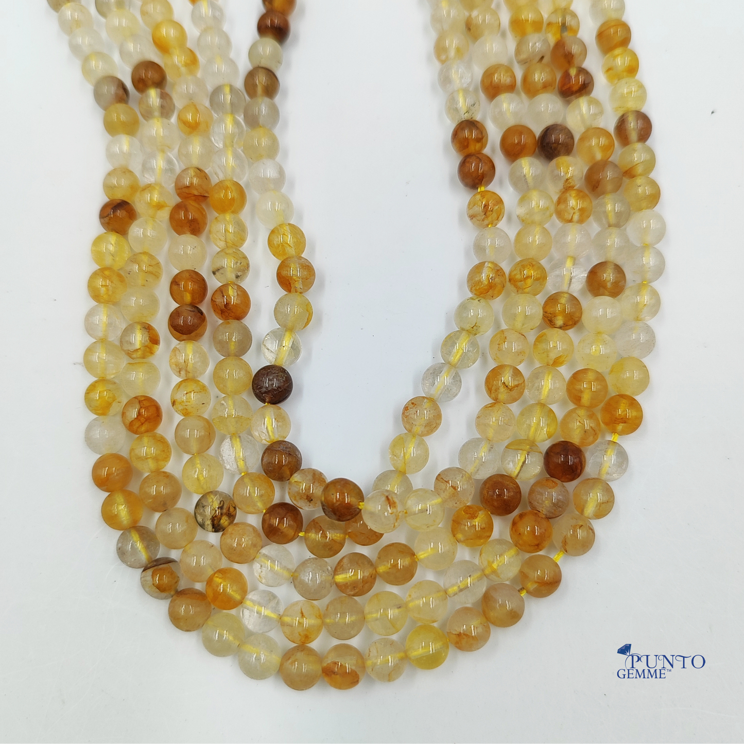 Filo di Quarzo di Limonite disteso su uno sfondo neutro per mostrare l'uniformità del taglio.