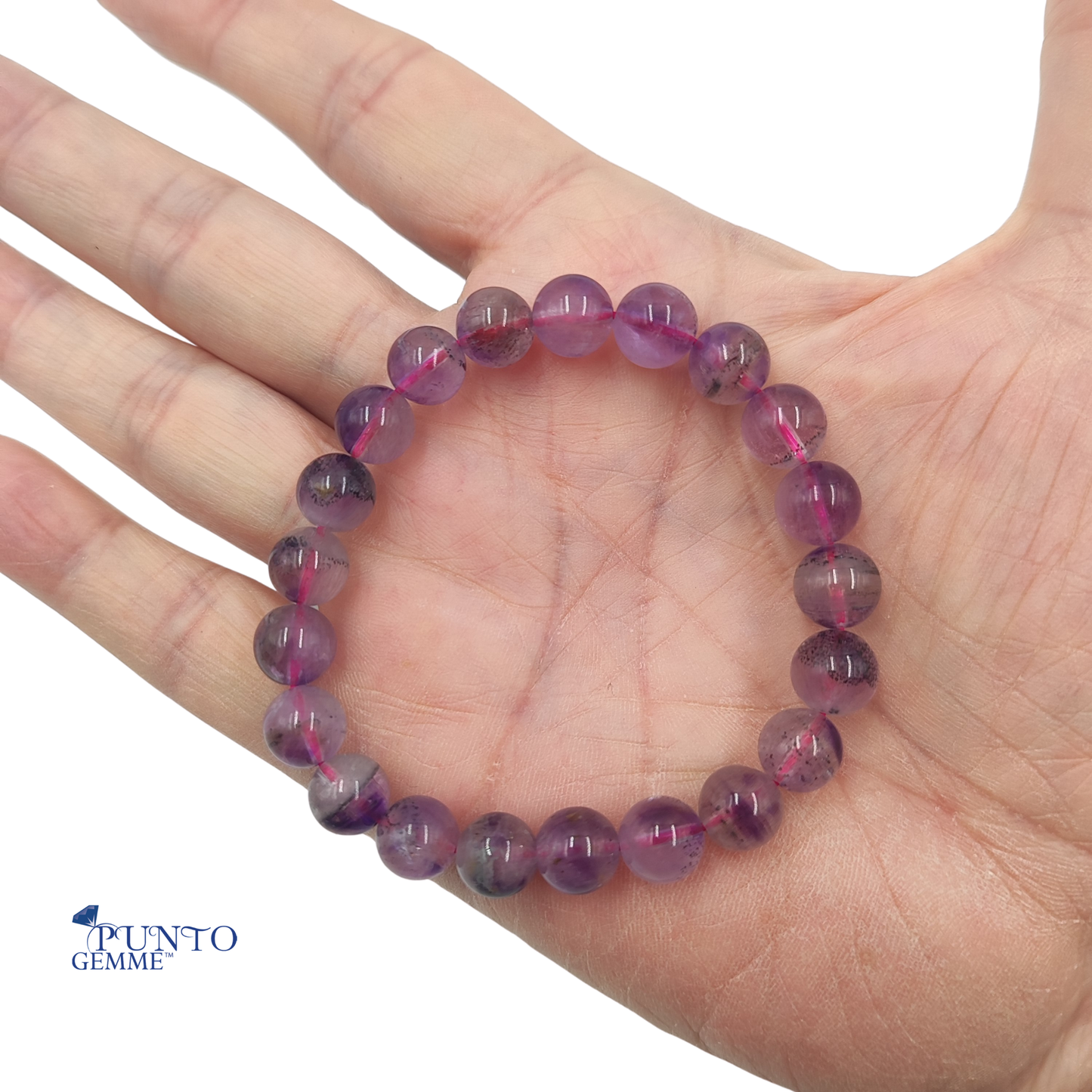 Dettaglio macro delle perle del bracciale Super Seven, evidenziando la complessità dei 7 minerali interni.