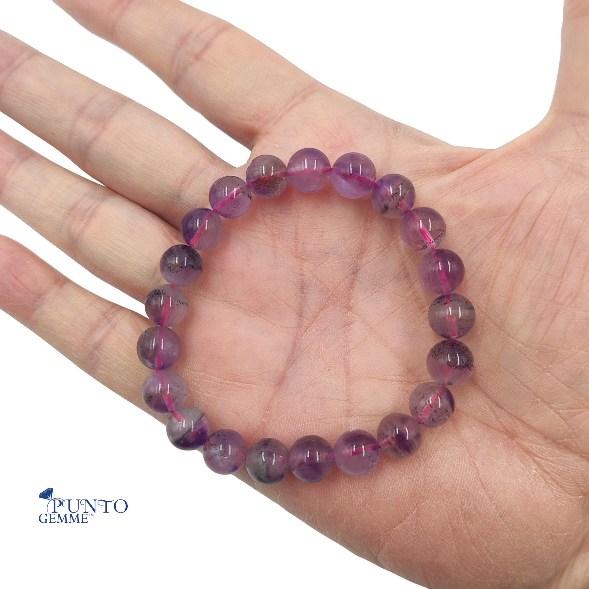 Dettaglio macro delle perle del bracciale Super Seven, evidenziando la complessità dei 7 minerali interni.