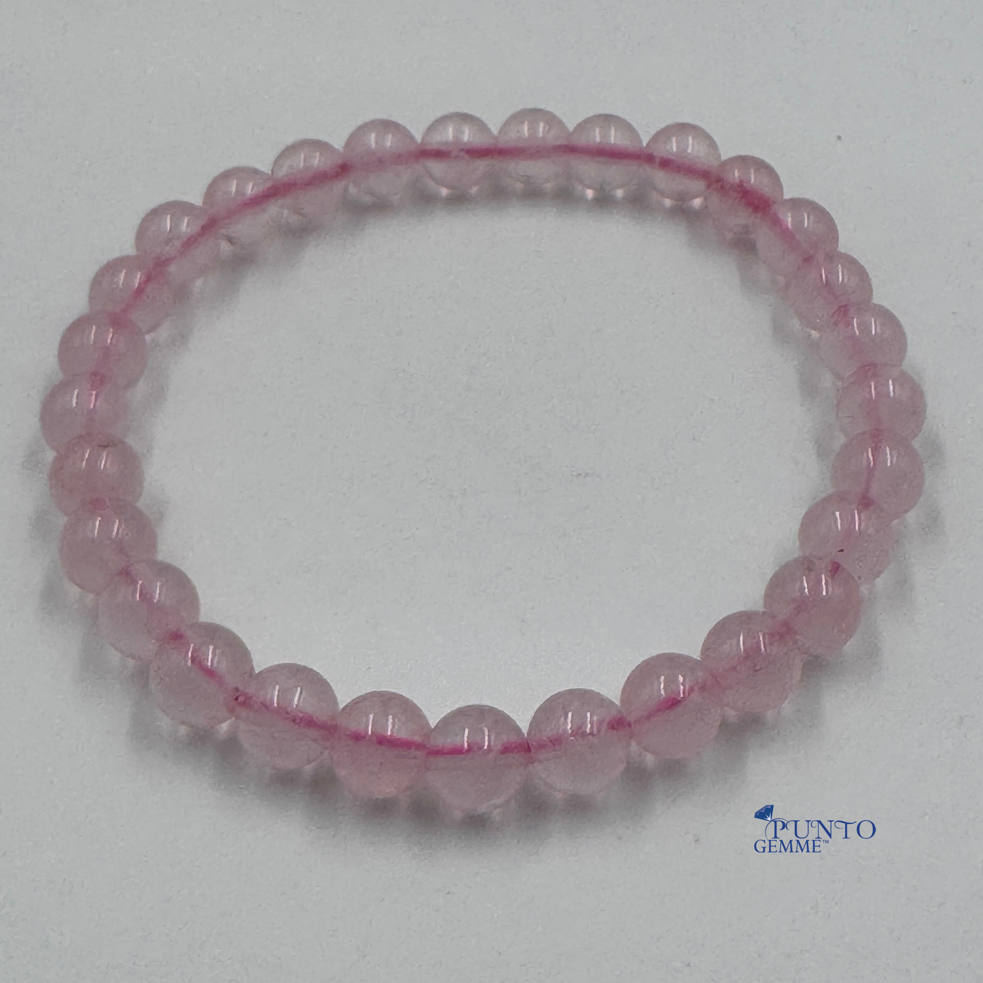Foto completa del bracciale Quarzo Rosa 6mm tondo liscio (Taglia M), colore rosa pallido.